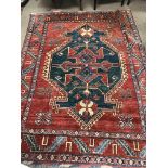 A Persian style rug with geometric pattern on a to