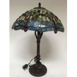 A large Tiffany style lamp, decorated with Dragonf