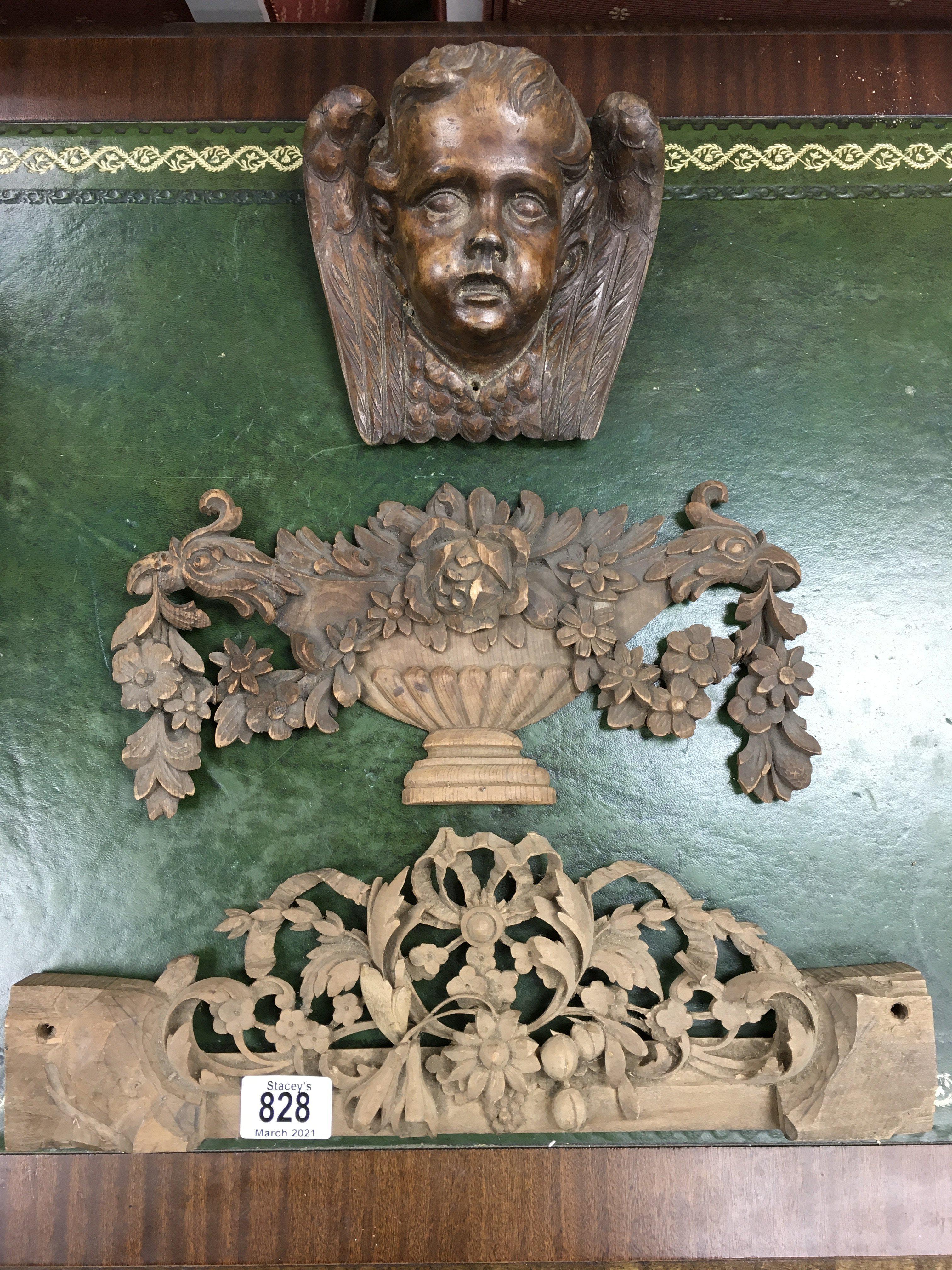 A carved cherub wall sconce and 2 additional carved wooden panels