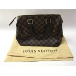 A Louis Vuitton hand bag in it’s original box with