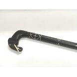 An ebonised walking stick elephant head handle.