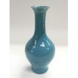 A small Oriental blue vase with an elongated neck,