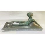 An Art Deco Patinated Bronze Sculpture of a reclin