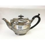 A hallmarked silver teapot with reeded design and