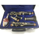 A cased Couesnon clarinet.