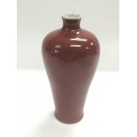 A small red Meiping vase, approx 15.5cm.