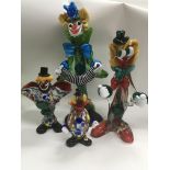 Four Murano glass clowns.