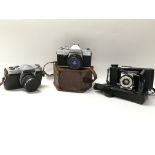 A collection of three vintage cameras. Three brand