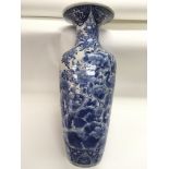 A blue and white Oriental floor vase with floral d