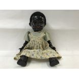 A 1950s pedigree black composition doll.