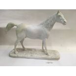 A Portuguese white porcelain figure of a horse aft