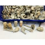 A collection of early clay pipes in varying condit