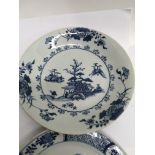 A Chinese Nanking cargo blue and white plate decorated with a village scene and one other Chinese