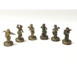 A set of 6 brass cherubs playing various musical i