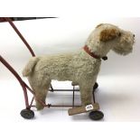 A vintage push a long toy dog on wheels. NO RESERVE