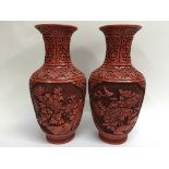 A pair of Chinese Cinnabar vases decorated with flowers and foliage. Height 31.5cm approx