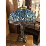 A large Tiffany style dragonfly lamp with a cast bronze base. ( shade diameter 61cm), Height 91cm.