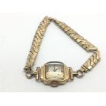 A vintage 18ct gold cased watch on a 9ct gold expa