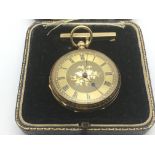 A 14ct gold ladies fob watch with bright cut decor