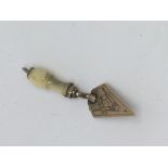 A 9ct gold trowel charm with a Masonic emblem.