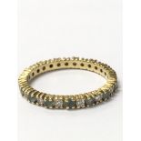 An unmarked eternity ring with alternating aquamar