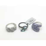 Two silver and topaz rings and one other ring (3)