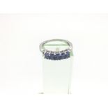 A silver ring marked 925 and set with tanzanite, a