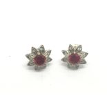 A pair of 9ct gold earrings set with red stones an