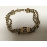 A 9carat gold triple strand bracelet the clasp set