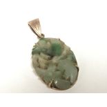 A vintage circa 1920/30 carved jade oval pendent s