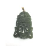 A jade pendant in the form of a Buddha head with 1