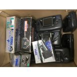 A box of Sega game gears, TV tuner pack, magnifier