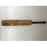 A signed cricket bat. Signatures including Dennis