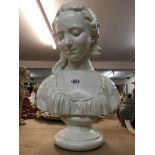 A plaster bust in the form of a Classical maiden.