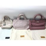 A collection of three pink leather designer Radley