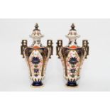 A pair of Royal Crown Derby porcelain vase and cov