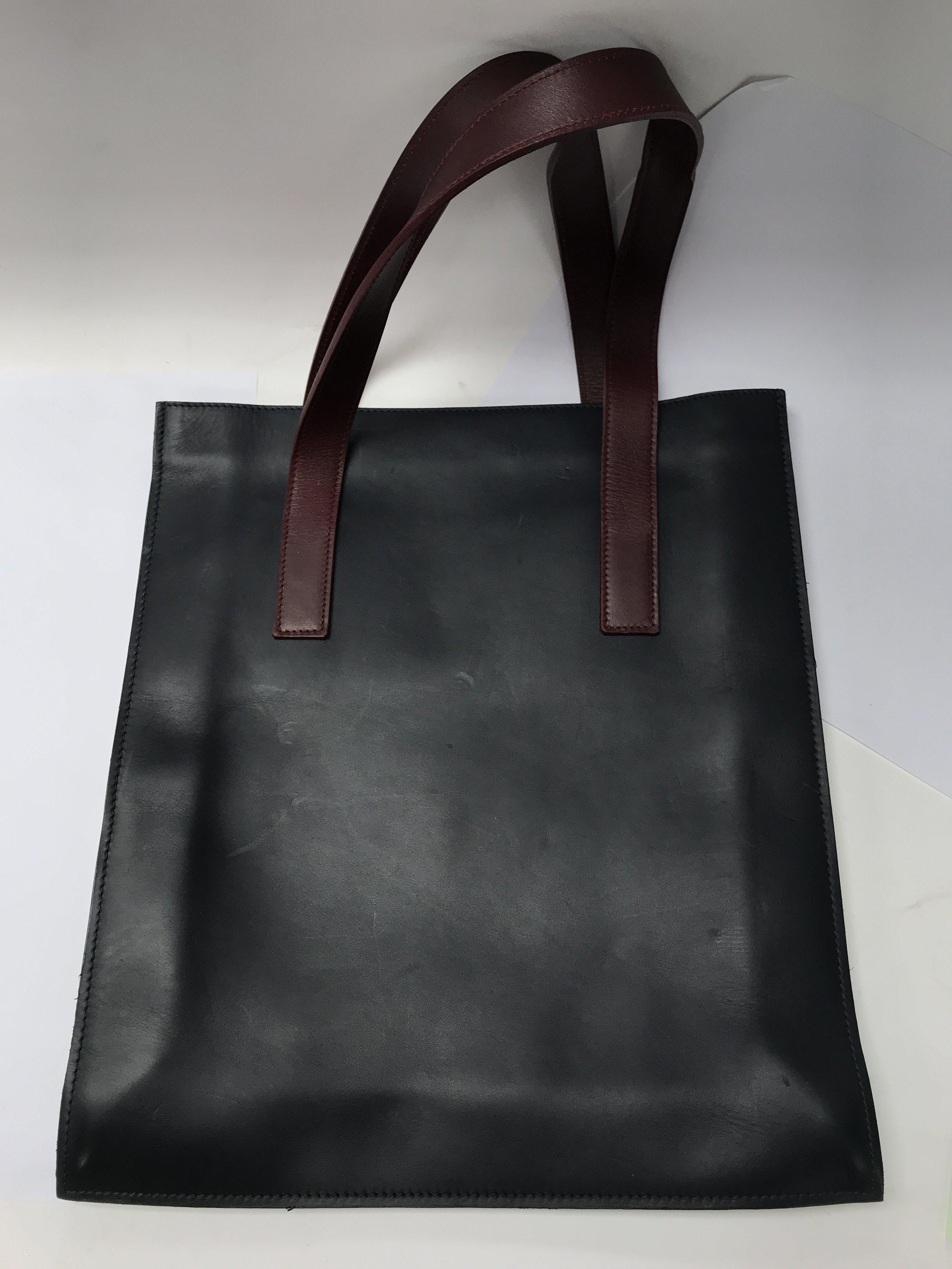 A good quality leather tote bag, dark blue and bur
