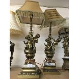 A pair of brass classical style lamps in the form