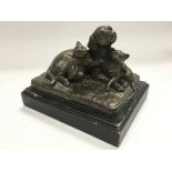 A bronzed figural group of a dog and two cats and