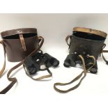 Two pairs of cased military binoculars.