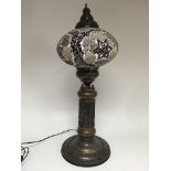 A large Moorish style lamp, in colours of brown, g
