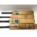Four vintage cricket bats.