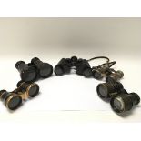 Five pairs of vintage binoculars.