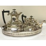 A silver plated tea set and an oval gallery tray