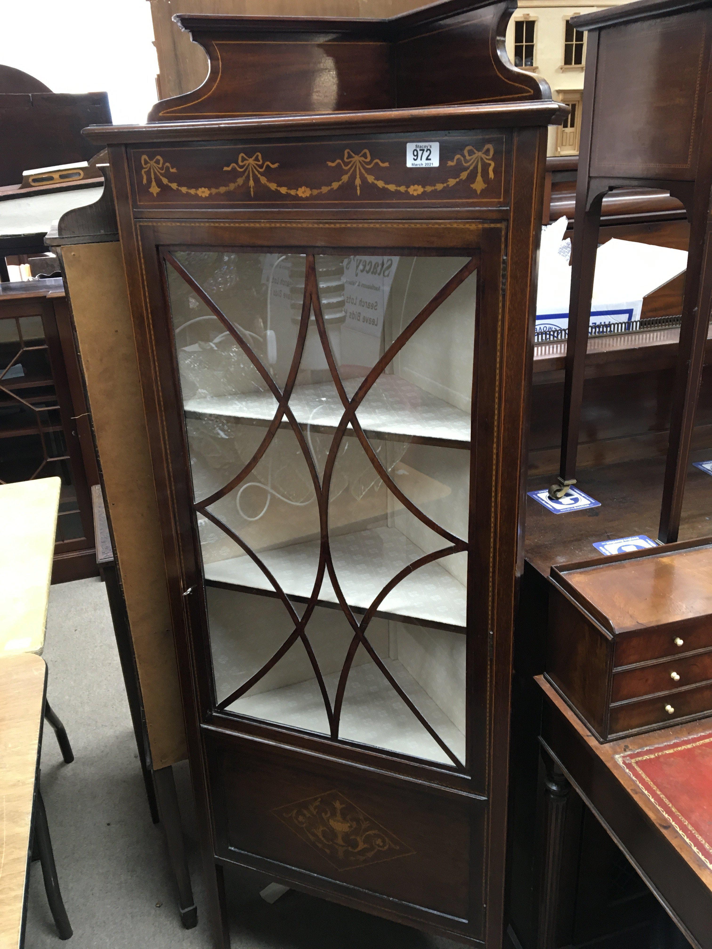 An Edwardian corner cabinet with simulated ribbon