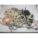 A collection of pearl necklaces and bracelets.