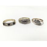 A collection of three rings - one gold ring set wi