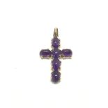 A 9ct gold cross set with cabochon amethyst