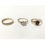 A collection of three rings - one gold ring set wi