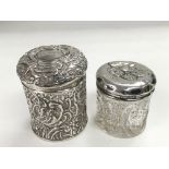 A silver dressing table tidy jar with scroll work